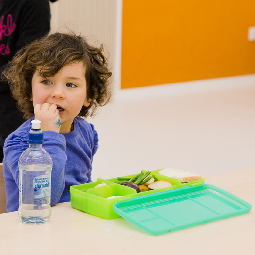 A preschooler eating lunch at Spotted Frog Preschool