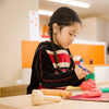 Preschooler playing with playdough at Spotted Frog Preschool